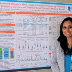 Megha Sharma, M.D., poses with a poster about her Implementation Science Scholars project.