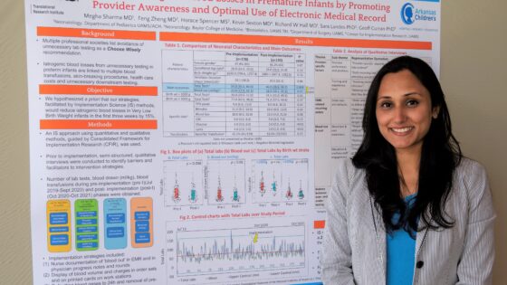 Megha Sharma, M.D., poses with a poster about her Implementation Science Scholars project.