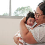 A Marshallese woman holds her baby