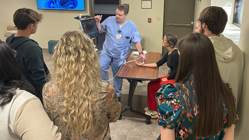 A medical provider demonstrates a sonogram machine.