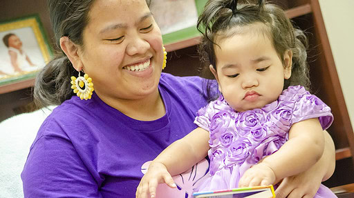 Marshallese mother reading to her baby