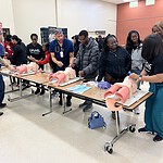 Representatives from the UAMS College of Nursing guide students through a demonstration of how to intubate patients.