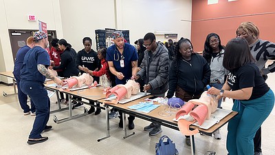 Representatives from the UAMS College of Nursing guide students through a demonstration of how to intubate patients.