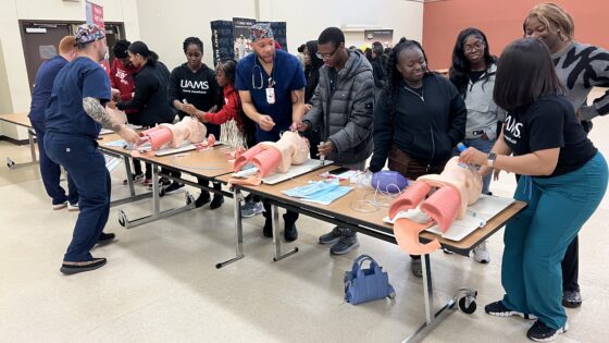 Representatives from the UAMS College of Nursing guide students through a demonstration of how to intubate patients.