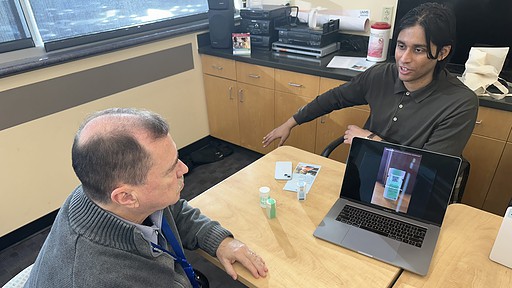 Sonara Health Business Operations Manager Kshitij Verma (right) demonstrates how to use the online repository to Jere Brewer of UAMS’ Center for Addiction Services and Treatment.