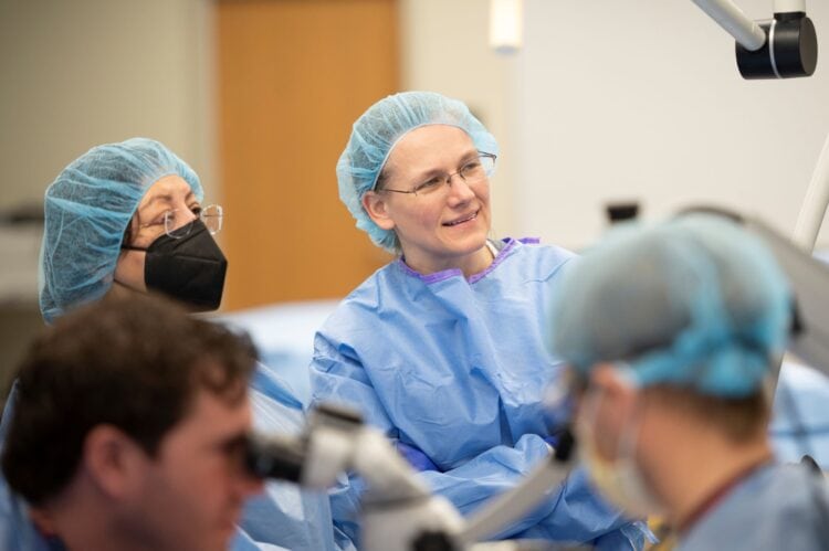 Erika Petersen, M.D. (center), with Ranu Jung, Ph.D. (left), and (foreground) Mark Tait, M.D., and John Bracey, M.D., during preparation for the surgery.