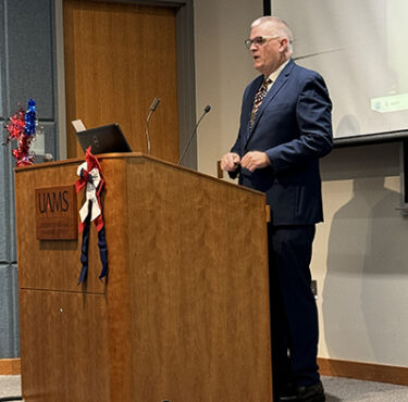 Nathan Johnson, right, speaks at a veterans appreciation event on Nov. 8 at UAMS.