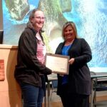 Gail Runnells, RN (left), receives the Bonny Hope Wallace Award from Jennifer McClusky, UAMS research compliance manager.