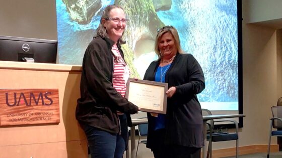 Gail Runnells, RN (left), receives the Bonny Hope Wallace Award from Jennifer McClusky, UAMS research compliance manager.