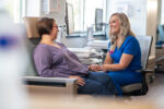 A nurse speaks to a cancer patient in the hospital