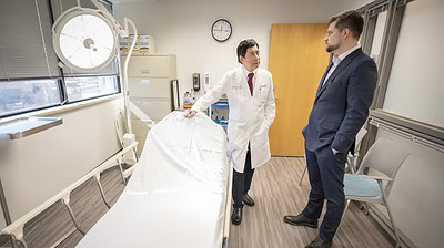 James Yuen, M.D., chief of the UAMS Division of Plastic and Reconstructive Surgery, visits with David Sterling, M.D., a cosmetic surgery specialist, in the new clinic.