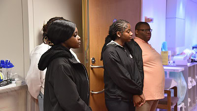 Students from Hall STEAM Magnet High School’s health sciences academy stand outside an imaging room at the UAMS Winthrop P. Rockefeller Cancer Institute. From the doorway of the room, they viewed an MRI machine and learned about the precautions employees take to ensure safety around the machine’s strong magnetic field.