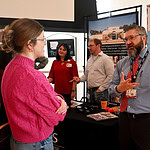Matthew Nix, M.D. (right) talks with a student at the recent UAMS Residency Fair.