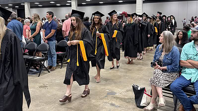 Graduating College of Health Professions students proceed in a long line up to the Statehouse Convention Center stage at the start of the college's May 16 commencement ceremony.