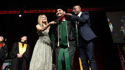 Each student was assisted onstage by family, friends or members of the faculty as they received their doctoral hoods.