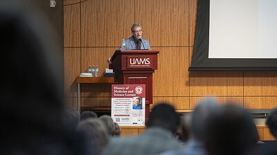 Author Jack El-Hai entertains a crowd at the Jack T. Stephens Spine & Neurosciences Institute at UAMS.