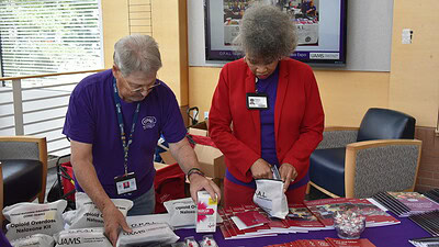 Randy Henderson, clinical research associate in the College of Medicine’s Department of Geriatrics, and Regina Gibson, program manager for the OPAL Program, distribute naloxone kits during the Drug Takeback Day event at the Donald W. Reynolds Institute on Aging.
