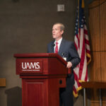 Chancellor Cam Patterson, M.D., MBA, speaks to employees during a town hall meeting in May.