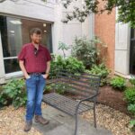 Tyler Priddy stands outside in a UAMS garden in May, after a follow-up appointment.