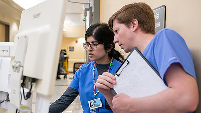 UAMS residents looking at a computer screen
