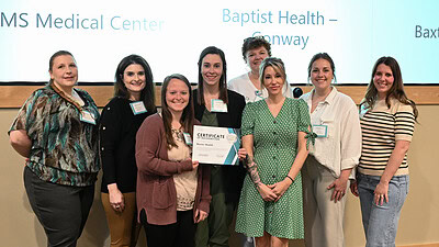 Representatives from Baxter Health accept their platinum banner for their accomplishments during the ARPQC’s recently completed “Safe Reduction of Primary Cesarean Birth” initiative.