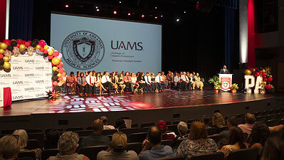 Edward Williams at the lectern addresses the audience at the Valediction Ceremony for the Physician Assistant Studies' Class of 2025.