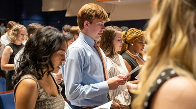 A close-up of students reciting the medical student oath.