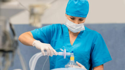 A nurse anesthesist prepares a patient for surgery