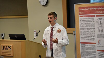 Mason DeLaMater, a Cabot native and rising sophomore at Princeton University, presents his findings during the closing ceremony for UAMS’ Summer Research Internship program.