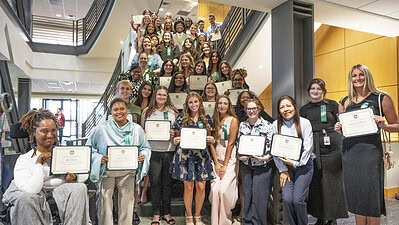 College of Health Professions, student scholarship recipients gather on the staircase in the Bruce Commons are of the Rahn Building.