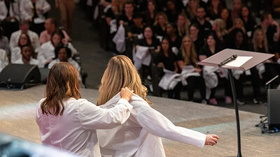 A student dons her white coat during a ceremony for the UAMS College of Nursing. The college placed 59th in U.S. News & World Report’s latest rankings of undergraduate nursing programs.