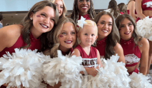 Collins Johnson, daughter of UAMS employee Annabeth Johnson, enjoys meeting the Razorback cheerleaders.