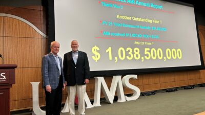 Jay Silveria (left), president of the University of Arkansas System and chair of the Arkansas Biosciences Institute (ABI) Board of Directors, and Robert E. McGehee Jr., Ph.D., ABI executive director, announced the $1 billion milestone during ABI’s annual meeting.