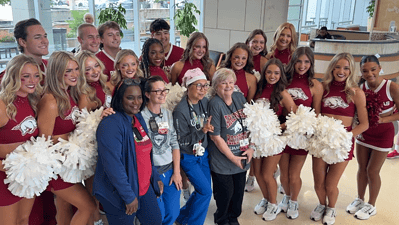 Team UAMS members enjoy a quick picture with the University of Arkansas Spirit Squad.