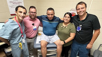 Ramsey Ghaleb, left, Brian Rayburn, Juan Campos and his wife, and Bruno Machado take a moment to visit and celebrate after the first surgical procedure at 12th Street Health & Wellness Center.