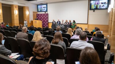 TRI Director Laura James, M.D., (standing left) moderates a panel of implementation scientists representing institutions in the Consortium of Rural States.
