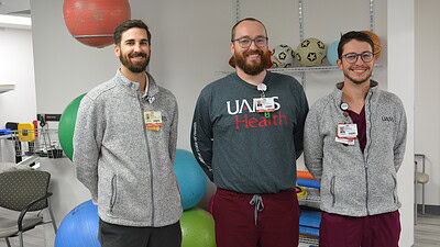Photo of Sean Stone, Austin Miller, and Jesse Edwards in the UAMS Health Outpatient Therapy Clinic in Fayetteville