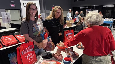 Employees from the UAMS Heart Center hand out information at the 2025 Health & Wellness Expo.