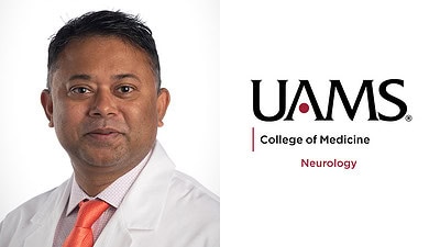 White-coat portrait of Dr. Sriwastava with UAMS logo