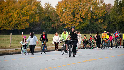 Students, parents, and community members walking and riding bicycles to school