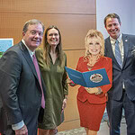 Posing for a photo around the life-sized cardboard cutout of Dolly Parton are, left to right: D. Lowry Barnes, M.D., interim chancellor at UAMS; Gov. Sarah Huckabee Sanders; State Sen. Clarke Tucker; and Laura Landreaux, president and CEO of Entergy Arkansas.