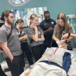 Students learn to intubate on a manikin at the 2025 MASH camp in Cabot.