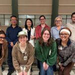 group photo: Yunmeng Liu, Ph.D., in white coat, with members of her laboratory.