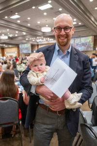 Andrew Delo, with daughter, is all smiles about matching to a Med-Peds residency at UAMS.