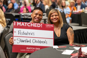 Jarod Canonigo, president of the Class of 2026, announces his match to a pediatric residency at Stanford Health Care in California.