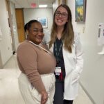 Jazmin Johnson, patient, and her doctor, surgeon Lexie Vaughn, pose for a picture together in a hallway at UAMS.