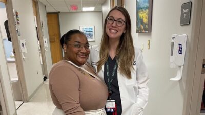 Jazmin Johnson, patient, and her doctor, surgeon Lexie Vaughn, pose for a picture together in a hallway at UAMS.