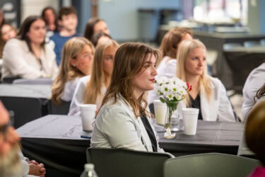 Scholarship assistance is critically important for participants in the accelerated Bachelor of Science in Nursing program, as they sometimes spend 50 to 60 hours per week on course work. Here, the students are seated at tables during the scholarship reception.