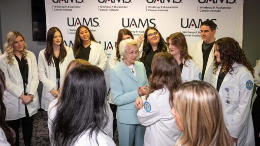 Students gather around an attendee at the scholarship reception. The UAMS College of Nursing held the Feb. 26 reception at the Northwest Regional Campus in Fayetteville to award $2,000 in scholarships to every member of the accelerated Bachelor of Science in Nursing program.