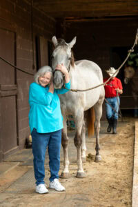 A year after receiving SAINT® Depression Therapy and getting her life back, Sandy Rasmussen enjoys spending time with horses.